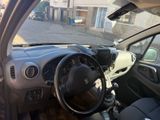 a small car that is parked in the street