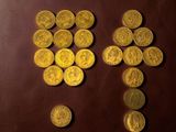 a lot of gold coins on a brown table
