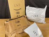 three bags of food sitting on top of a wooden table next to a cardboard box
