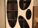a picture of a bookcase with a black and white design on it