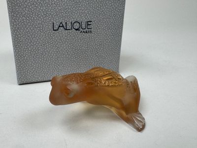 an image of a glass animal figurine in front of a box