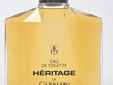 a close up of a bottle of perfume on a white surface