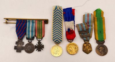 several medals and medals are displayed on a white surface