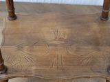 a small wooden table with a carved design on it