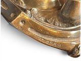 a close up of a brass clock on a white background