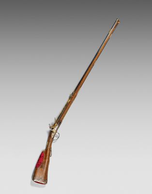 an old rifle with a wooden handle and a wooden barrel