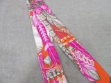 a pink and orange neck tie with a design on it