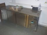 a refrigerator and a counter in a kitchen with a lot of counter space
