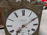 a clock that is sitting on the floor in the room