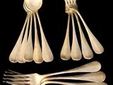 a lot of forks and spoons that are on a table