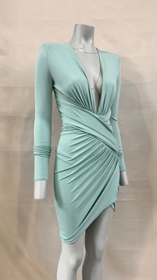 a mannequin wearing a green dress on a mannequin mannequin mannequin mannequin mannequin mannequin mannequin mann