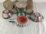 many different types of vases and bowls on the table