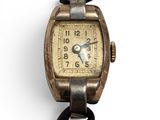 an image of a wrist watch with a leather strap on a white background