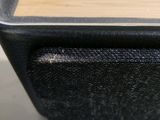 a close up of a black and wood box on a table