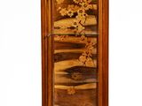 a tall wooden cabinet with a floral design on it
