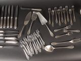 a lot of silverware on a table with spoons and spoons