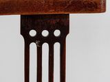 a close up of a wooden chair with holes in the back