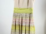 an image of a dress hanging on a hanger on a wall