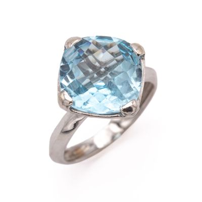 a close up of a ring with a blue topazt stone