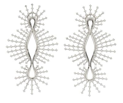 two pairs of silver earrings with white diamonds on them