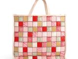 a close up of a pink and red bag on a white background