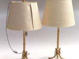 pair of brass table lamps with linen shades on each of them