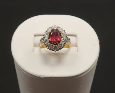 a close up of a pink and white diamond ring on a stand