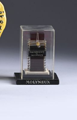 a watch in a glass case next to a clock
