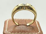 a close up of a gold ring on top of a brown leather box