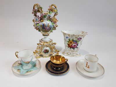 quatre tasses et soucoupes ainsi qu'un vase sur la table