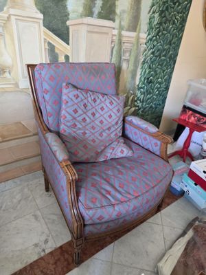 a chair that is sitting in front of a painting