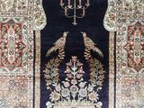 an image of a large rug with a bird design on it