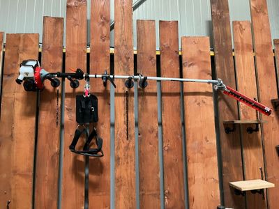 a man that is standing in front of a wall with tools
