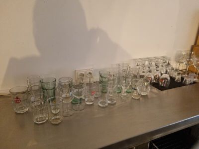 many glasses lined up on a table in a room