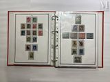 an open book with stamps on it and a cross on the cover