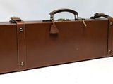 brown leather briefcase with brass handles on a white background