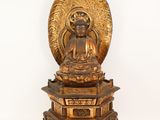 an image of a statue of a buddha sitting on top of a table
