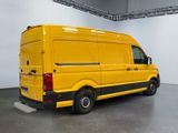 the yellow van is parked in the large room of the building