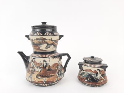 two teapots that are decorated with animals on them