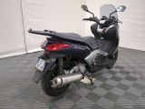 a motorcycle that is parked on the floor in a garage