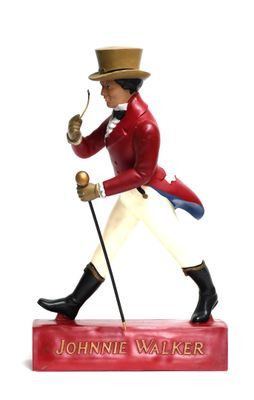 figurine of a man in a red coat and hat holding a cane
