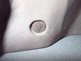 a close up of a coin sitting on top of a white bag