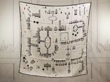 a black and white picture of a quilt hanging on a wall