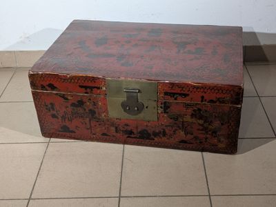 a red trunk sitting on the floor in a room