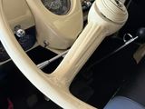 dashboard of a car with a steering wheel and a clock in the center