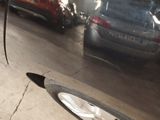 a car that is parked in a garage with a broken tire