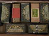 several boxes of different types of cigarettes are in a cardboard box