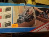 a box with a picture of a person using a planer