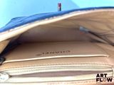 a purse that is open and has a notepad inside of it