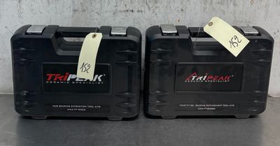 two black cases with tags on them are sitting on a table